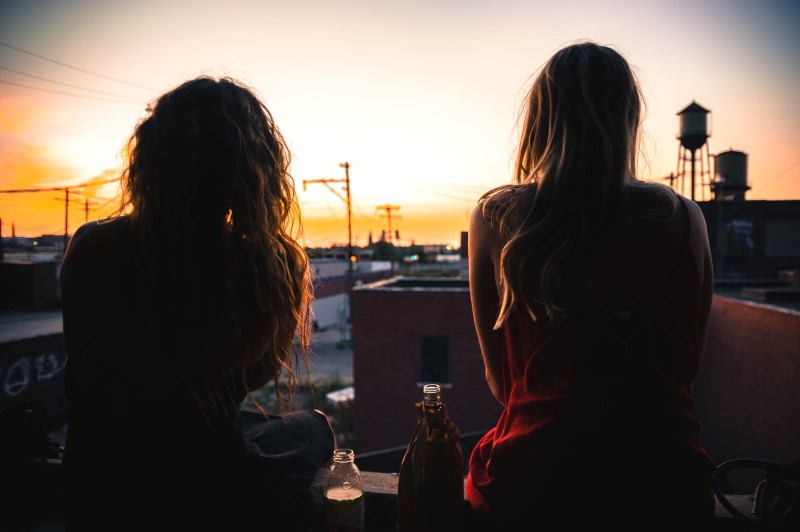 two women sitting on a rooftop in Detroit, Michigan