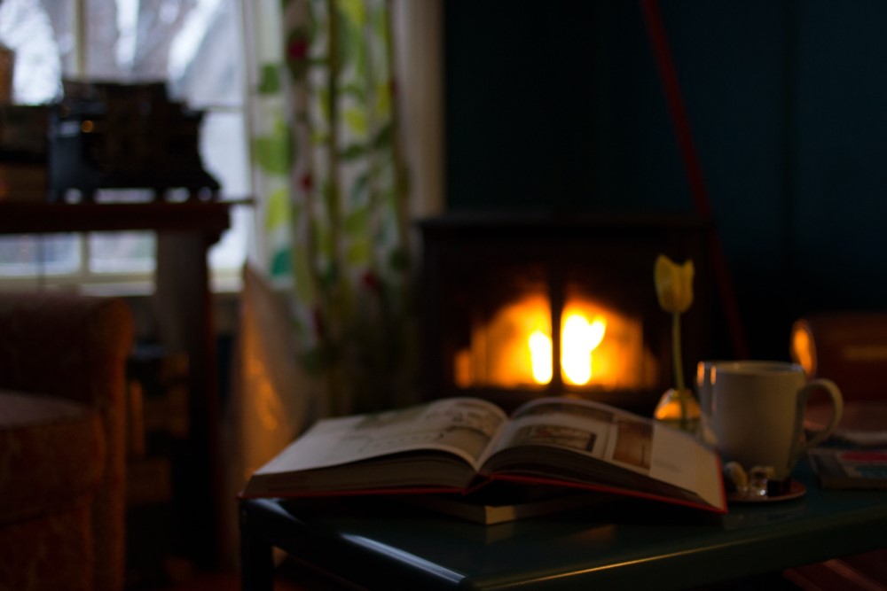 open book by cozy fire