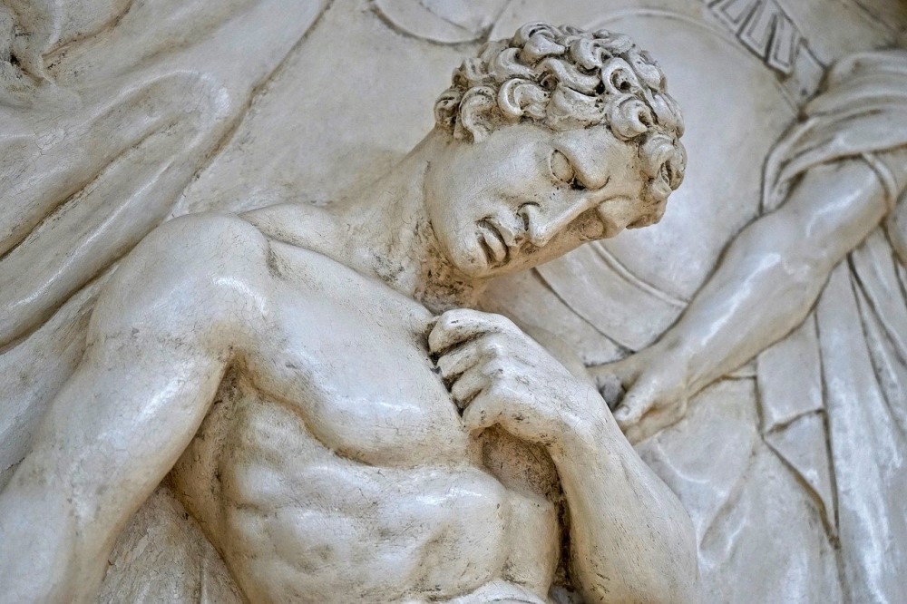 white stone sculpture of man