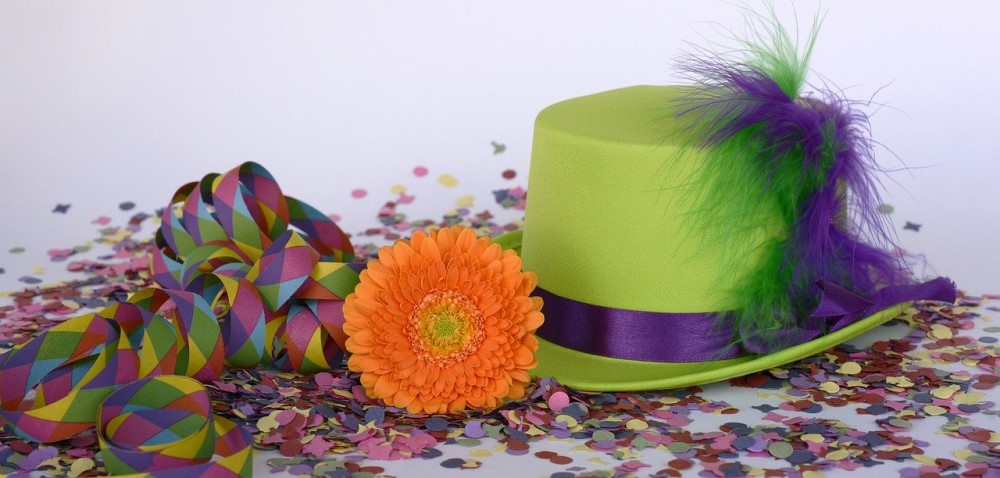 party confetti with ribbon and flower and hat