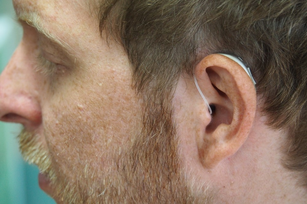man with hearing aid in ear