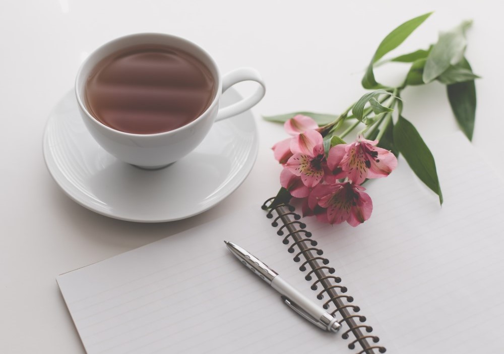 tea notebook pen flowers