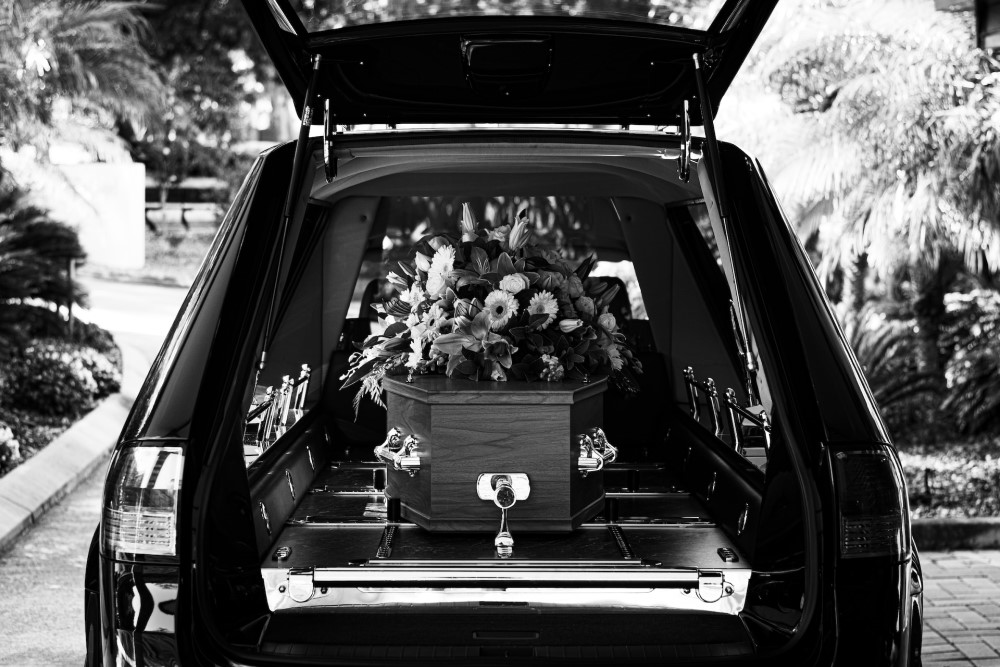 casket with flowers in hearse