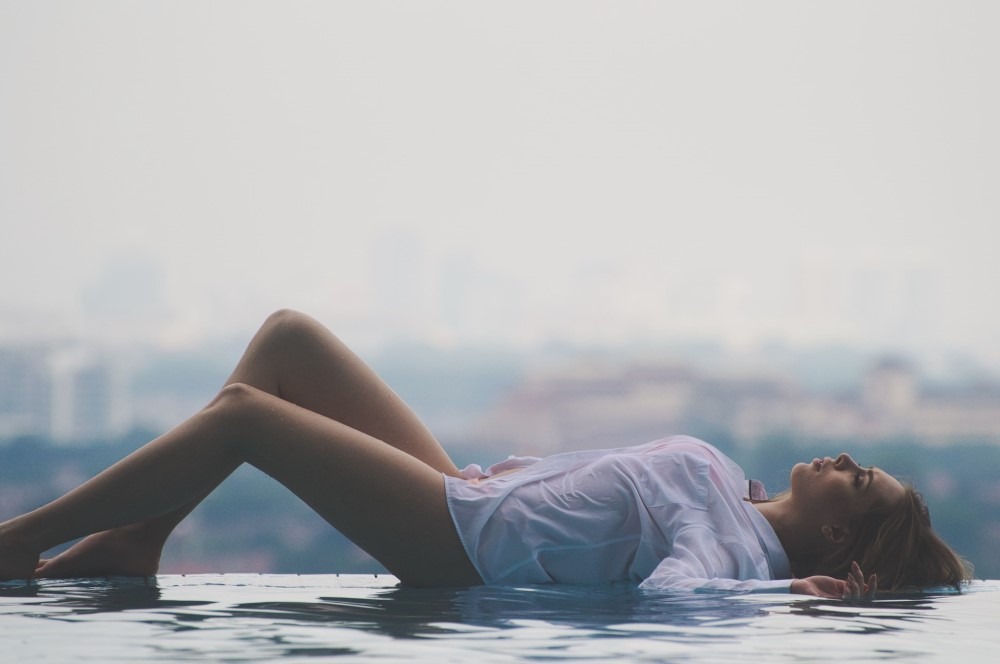 woman lying on poolside