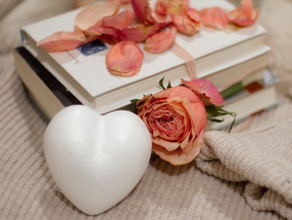 books wrapped with peach colored flowers with heart and sweater